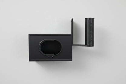 White wall-mounted WipeWorks bathroom dispenser for flushable wipes and toilet paper. demonstrating  wipe refilling.