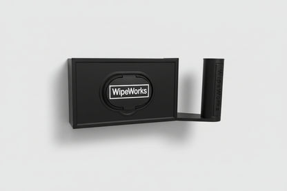 Black wall-mounted WipeWorks bathroom dispenser for flushable wipes and toilet paper