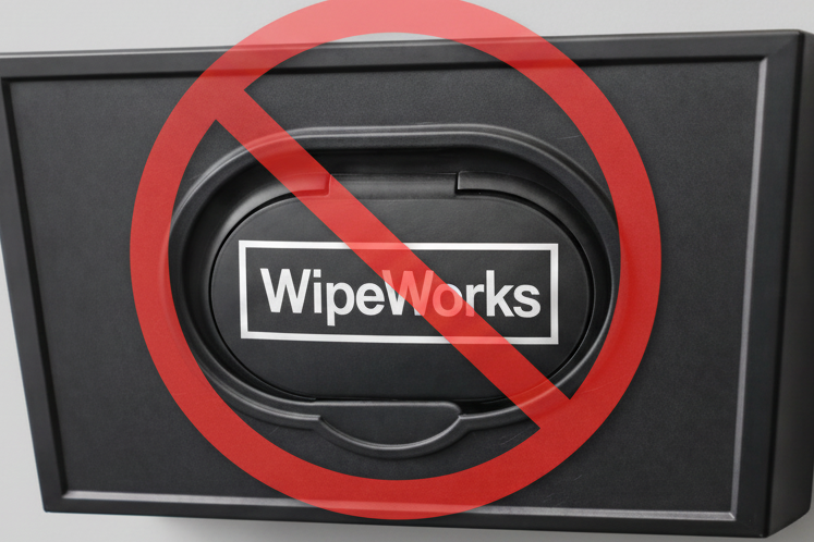 WipeWorks product with a red 'no' symbol over it on a white background demonstrating the problem with other wipe dispensers
