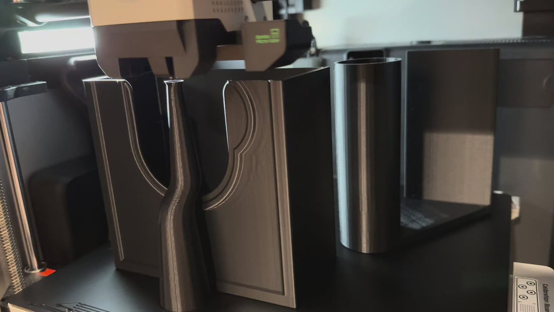 Close-up video of a WipeWorks wall-mounted bathroom holder being 3D printed, showing the dispenser shape forming layer by layer during manufacturing.